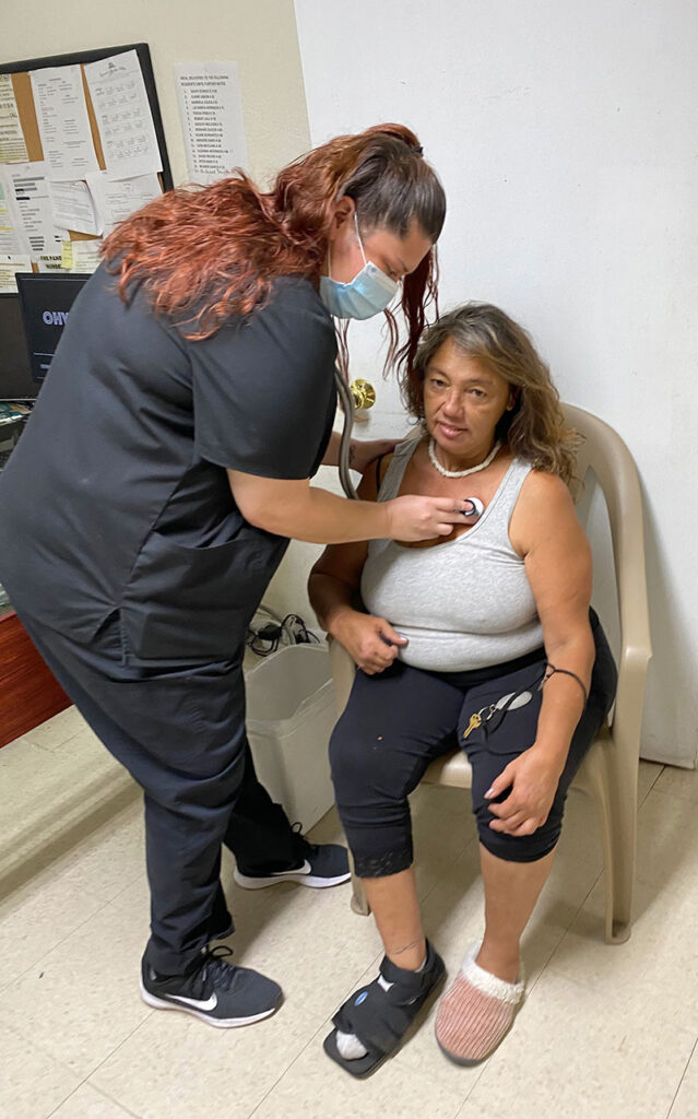 a woman checking an elderly woman